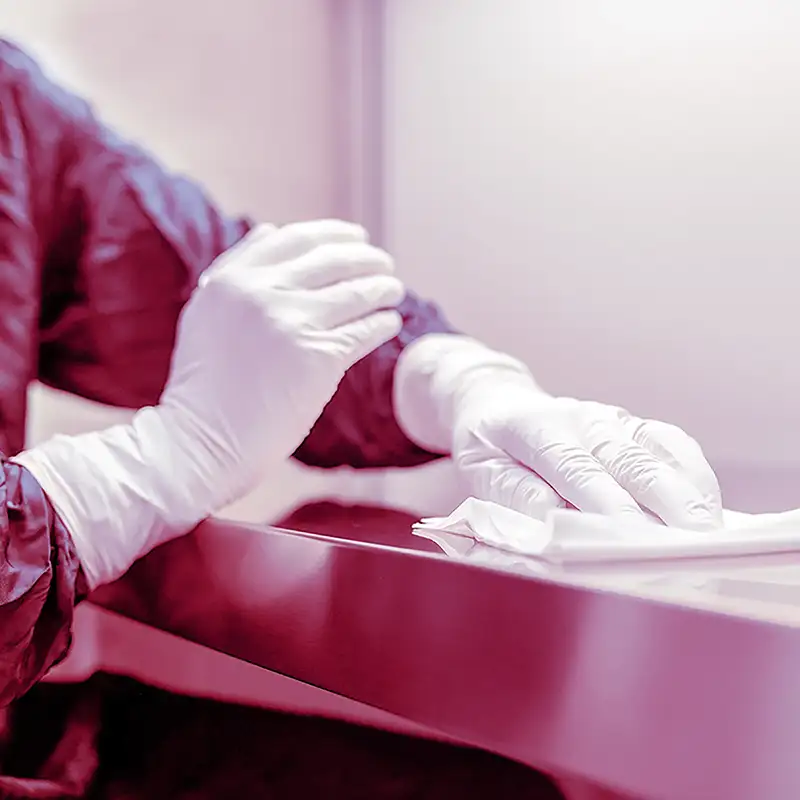 Close-up of hands in gloves, cleaning a surface with cloth | Protect2Clean